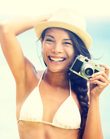 Beach woman with vintage retro camera