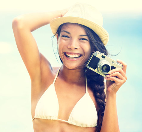 Beach woman with vintage retro camera